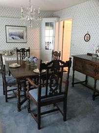 Carved walnut dining table with 3 leaves, 7 side chairs and 1 captain chair from 1830s. Table is 3’ 8” wide by 5’ long plus 3 leaves to extend it up to 8’. Table pads included.