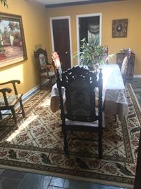 Six sturdy ornate chairs and dining table to feast upon 