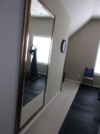 Large floor to ceiling mirror with beveled edge in workout room great for entry piece or statement piece in any room, black rubber tiles for workout flooring!