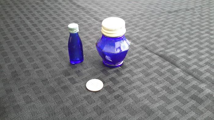 Vintage tiny blue bottles; Vicks bottle on left, Ironized Yeast bottle on right.