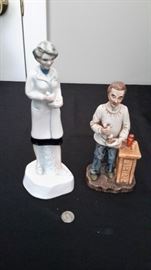 Vintage doctor figurines holding mortar and pestles.