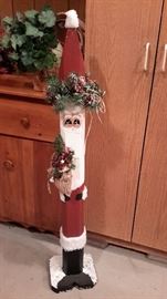 Tall wooden Santa decoration.