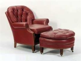 Oxblood Leather Club Chair and Matching Ottoman, tufted back, rolled arms, brass tacked with brass casters, manufactured by Hancock & Moore, North Carolina