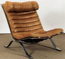 Arne Norell, Swedish, Mid-C. Modern Chromed Metal and Leather Lounge Chair, with matching brown leather headrest.