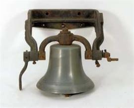 Cast metal bell with iron wall bracket. No visible foundry mark.