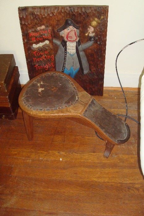 Old antique cobbler's bench and wood carving.