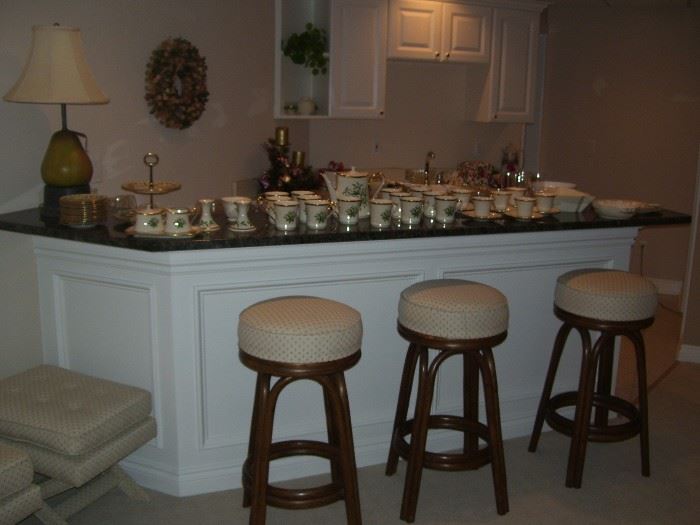 3 bar stools by Brown Jordan and a set of Lenox Christmas dishes.