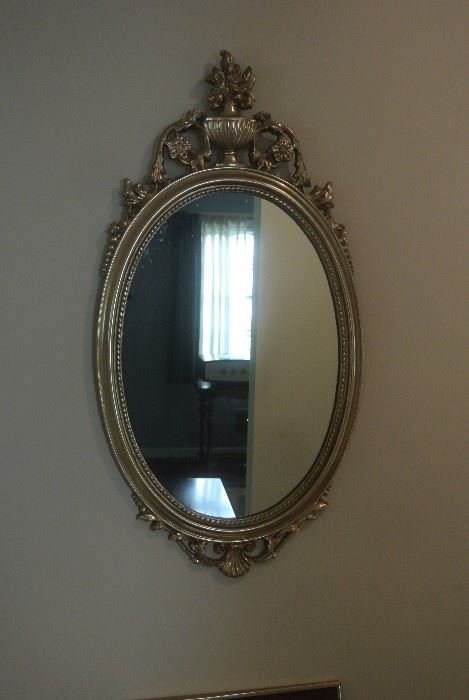 Hall mirror.  Hand carved wood frame.  Gilded.