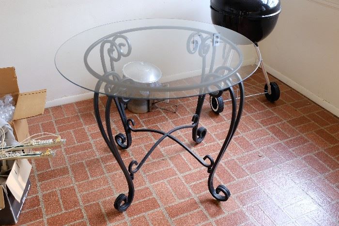 Wrought iron patio table with glass top.