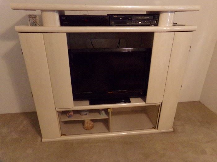 Blonde Wood Entertainment Center with Bi-Fold Doors on each side and Glass Doors in the Center/bottom