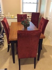 Expandable table with five matching velvet chairs