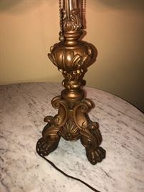 CLOSE UP VIEW OF TABLE BASE LAMP WITH BRASS PAW FEET