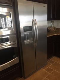 Kitchen Aid counter depth stainless refrigerator ith ice and water in door.