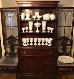 Antique mahogany breakfront cabinet. Large collection of milk glass.