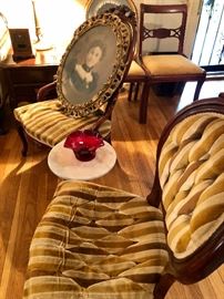 Pair of carved rose chairs with tufted velvet upholstery.
