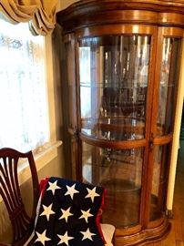 American flag with 48 stars. Large bow front china display cabinet.