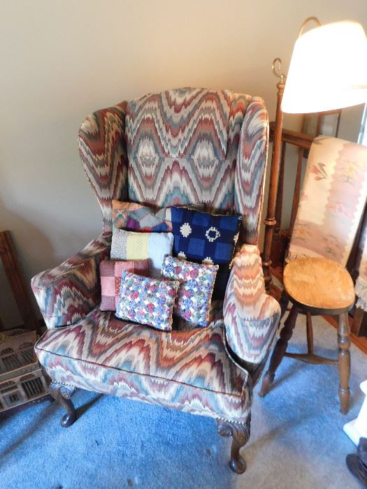 Modern wing chair with pillows made from vintage quilts