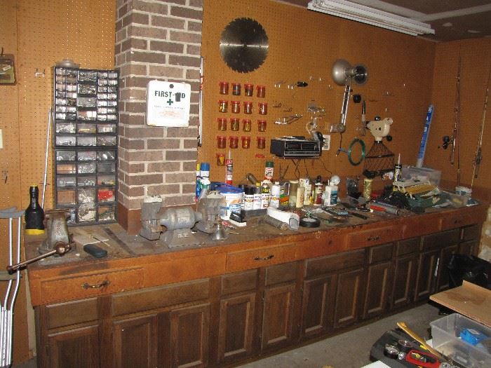 Workbench full of tools, grinder, vise and more. 