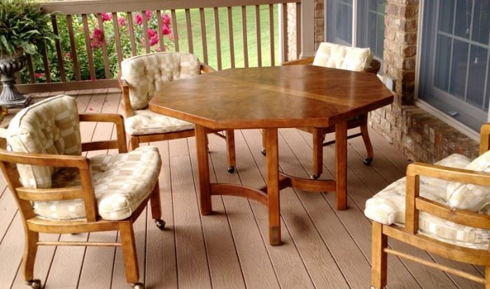 Nice wood table and 4 cushioned chairs on castors, perfect  for the main deck.