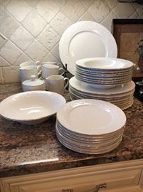 Beautiful white  Farberware  22K  gold rimmed dishes. 