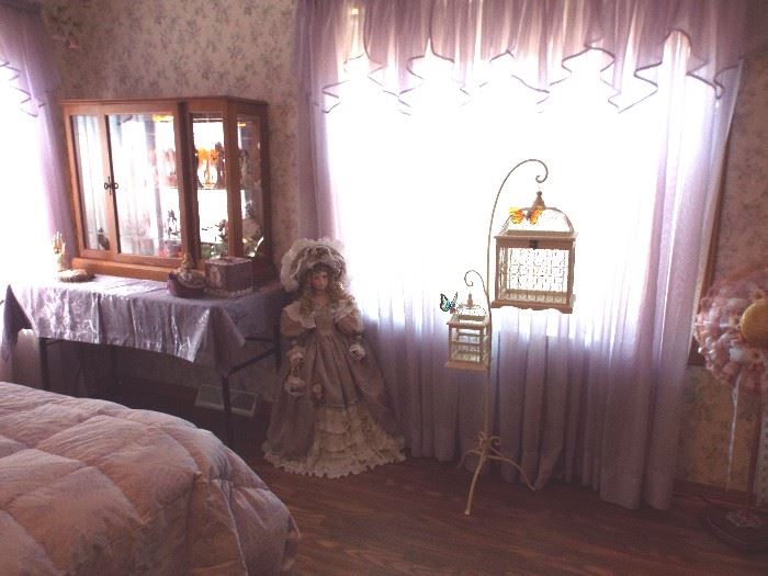Porcelain doll and double bird cage
