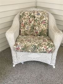 Wicker porch furniture - rocker, ottoman, side table, coffee table with glass top, loveseat + cushions. There are monkeys in the pattern of the fabric!