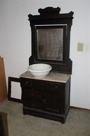 Dresser with marble top and ornate mirrored back