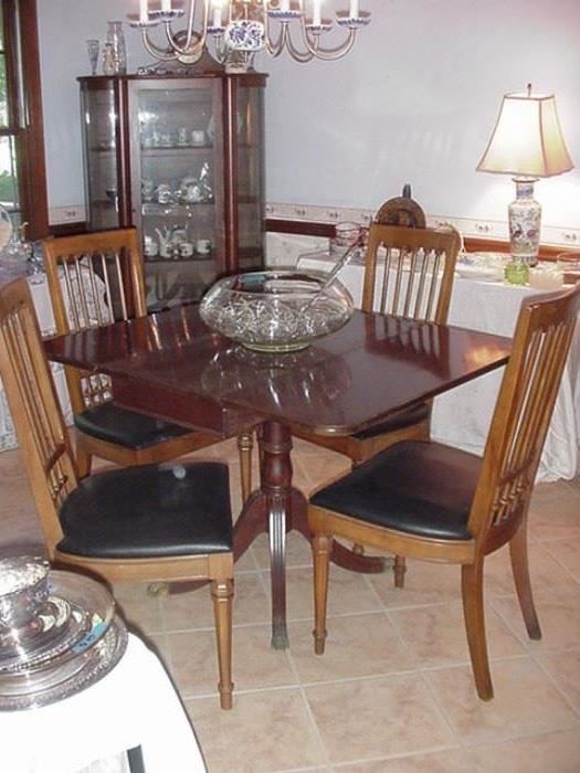 Dinging room drop leaf table with pedestal base in mahogany, and six Drexel walnut chairs, mid-century