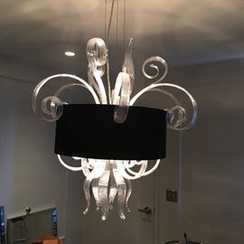 Mouth blown glass jellyfish chandelier with silver interior and black fabric shade. 