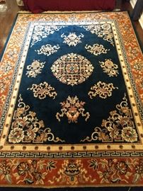 Machine made rug, 100% wool, measures 9' x 12'.