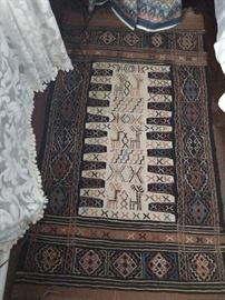 Vintage hand woven tribal Persian Baluch rug, measures 3' 6" x 4' 2".