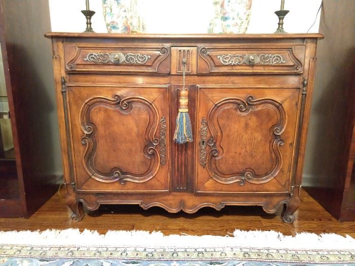 Antique French walnut hand carved server, with two drawers and double doors. 