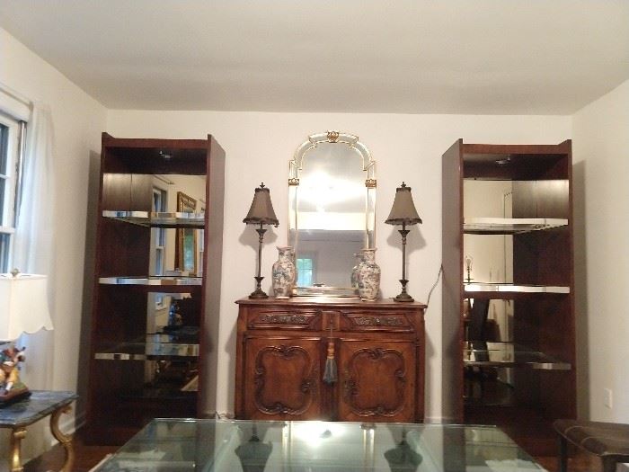 Pair of large mahogany lighted 3-glass shelf/chrome strip curio cabinets, with smoked glass backing, are from Hickory White's (Hickory, NC) "Gramercy" collection. 