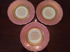 There is a set of eight of these pink rim, w/gold filigree & scalloped edge, 10" Black Knight dinner plates; three pictured for detail.                                                                                                       The Black Knight mark was used between about 1925 and 1941 - Graham & Zenger was a New York City based importer and wholesaler. The blanks were originally manufactured then designed and painted by the Hutschenreuther Porcelain Factories to be imported.     It is believed in the late 1930's, the company transferred their decorating company to the US while still buying their blanks from Germany. At the outbreak of WWII, Graham and Zenger and their Black Knight China brand ceased trading.
