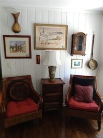 Nice pair of rattan armchairs, with matching side table. Original, artist signed artwork on wall.