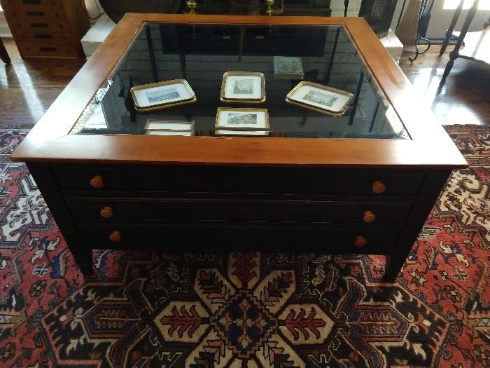 Three drawer coffee table, with beveled glass top, to display family treasures in the top drawer and all the remotes and medicinal herbs in the two lower drawers.
