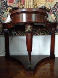 Close-up detail of the French mahogany curved front entry table leg.