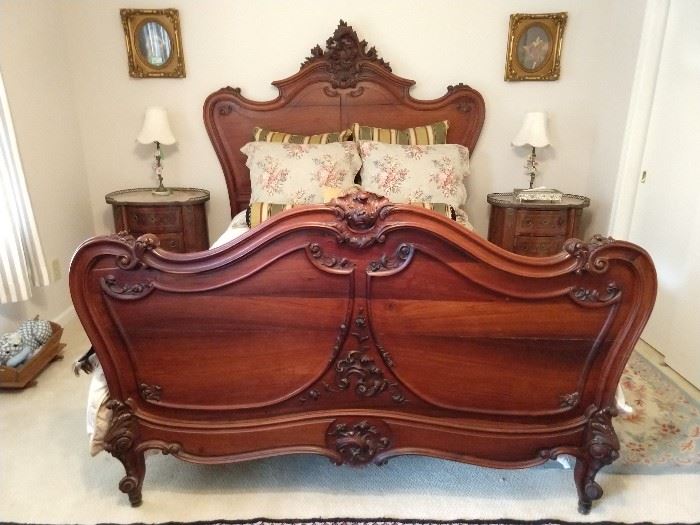 Antique French hand carved walnut full size bed, with appropriate linens, pair of antique French inlaid wood bedside table, with gallery and marble tops and a pair of vintage Italian table lamps with hand painted porcelain flowers, with matching finials and onyx bases.