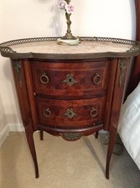 One of a pair of antique French inlaid wood side tables, with gallery, bronze mounts and marble top.