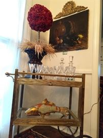 Love, Love, Love this vintage Parisian brass dessert cart! What makes this one so unique is the glass section below that is completely enclosed, + the glass rod handle is HOT! How that koi jumped in there, I have no idea. Celosia topiary lording over Waterford crystal decanters, while being stared down by the oil on canvas seafood still life, 1888, by listed French artist, Ernest Honnorat.