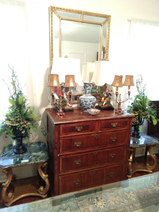 Antique English banded wood 5-drawer chest, with large gold wood/beveled glass mirror, flanked by a pair of vintage Italian Florentine side tables with green marble tops. 