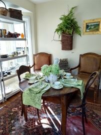 Small, round breakfast table, with three side chairs, old French market basket fern wall hanging. The "breakfast table" is a ca. 1810 French bread table, from Jane Marsden Antiques, purchased in the mid-90's when everyone had money, for $2,450.00. I'm in the wrong end of this business!