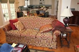 Three cushion sofa upholstered in red and gold medallion print