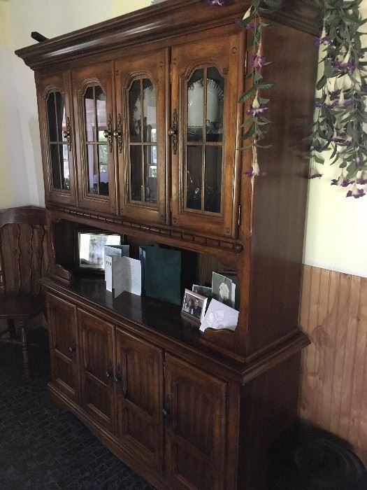 A very nice china cabinet that matches a table and chair set -- great for storage and displaying your favorites!