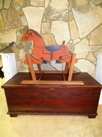 Vintage wooden rocking horse, antique cedar trunk