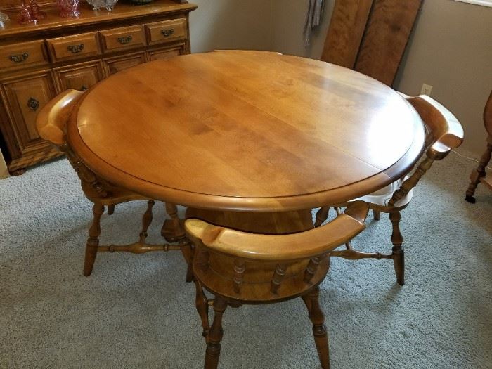 Maple Round Table with 2 Leafs and four Captain's Chairs. A wonderful piece. 