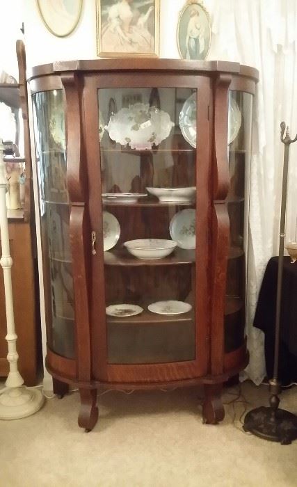 Antique oak china cabinet with curved glass