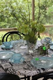 Round metal table and dishes on sun room.