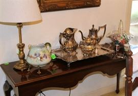 Sterling silver tray with water pitcher, coffee pot and creamer on table.