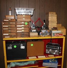 Stamps for a printing machine. Has several pieces and boxes and stamps in different colors.